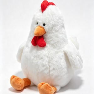 May include: A plush chicken toy featuring soft white fur, a bright red comb on top of its head, a red wattle under its orange beak, and two orange feet. The stuffed animal has small black eyes and a rounded, plump body shape in a seated position.