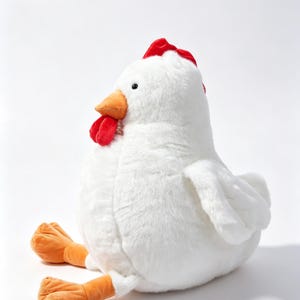 May include: A plush chicken toy featuring soft white fur, a bright red comb and wattle, an orange beak, and orange feet. The stuffed animal is depicted in a seated position with its legs extended forward, showcasing a rounded body shape.