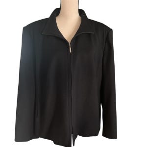 May include: A black jacket with a full-length zipper closure. The jacket has a stand-up collar and long sleeves. The fabric appears to be a smooth, woven material. The jacket is displayed on a mannequin.