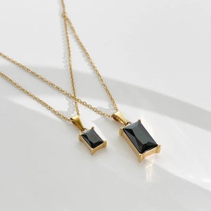 Gold necklace with black pendant sale