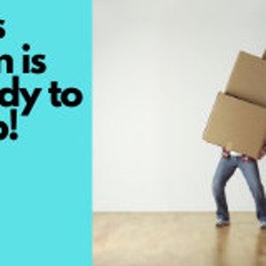 May include: A person carrying three stacked cardboard boxes. The boxes are brown and rectangular. The person is wearing blue jeans and a plaid shirt. Text on the left says "This item is ready to ship!"