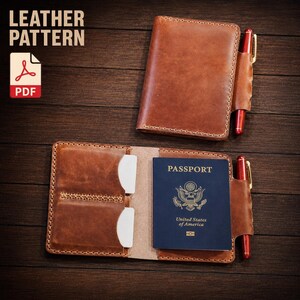 May include: A brown leather passport holder with visible stitching, a side pen loop, and a red pen. One holder is closed, and the other is open, displaying two white card slots and a blue United States passport. Text reads LEATHER PATTERN PDF.