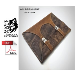 May include: A brown leather A4 document holder with two silver buckles and stitching. The holder is made by Grey Wolf Leather Patterns and is available as a PDF download.