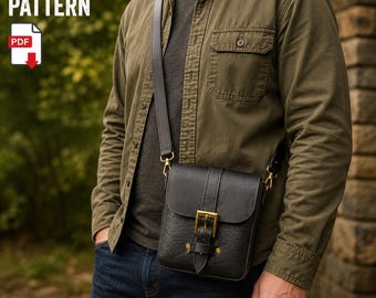 May include: A black leather crossbody bag with a flap closure, a brass-toned metal buckle, and an adjustable shoulder strap. The bag features a textured surface and is worn over an olive green button-down shirt and dark blue denim jeans.