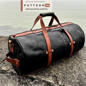 May include: A black duffel bag with brown leather straps and handles, featuring a top zipper closure and side handle. The text MUSAK PATTERNS PATTERN PDF FOR MACHINE SEWING is visible at the top of the image, indicating a sewing pattern design.