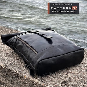 May include: A black leather roll-top backpack featuring a front zippered pocket, a buckled strap closure, and a smooth finish. The image includes text that reads MUSAK PATTERNS PATTERN PDF FOR MACHINE SEWING, indicating a digital sewing pattern.