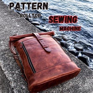 May include: A brown leather roll top backpack with a buckle closure and two zippered pockets. The text "PATTERN ROLLTOP SEWING MACHINE" is visible in the image.