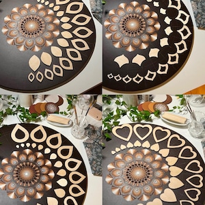 Puede incluir: Cuatro im&aacute;genes que muestran un proyecto de arte de mandala en progreso. La primera imagen muestra un c&iacute;rculo de madera marr&oacute;n con un dise&ntilde;o de mandala pintado en el centro. La segunda imagen muestra el mismo c&iacute;rculo con formas de madera en forma de hojas dispuestas alrededor del mandala. La tercera imagen muestra el mismo c&iacute;rculo con formas de madera en forma de gotas dispuestas alrededor del mandala. La cuarta imagen muestra el mismo c&iacute;rculo con formas de madera en forma de corazones dispuestas alrededor del mandala.