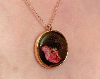 Pink glitter circle charm necklace.