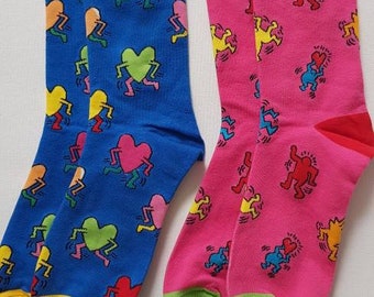 2 pairs of pop art socks. Lots of dancing hearts and little figures. Colourful and fun.