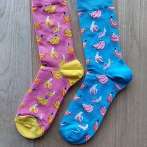 Two pairs of banana socks. Bright pink. Bright blue. Fruity socks. Go bananas!