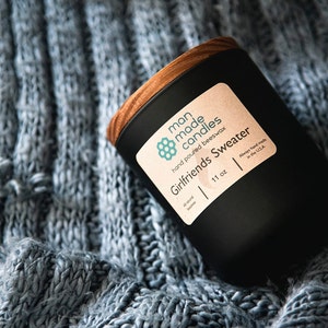Luxury Beeswax hand poured scented candle in matte black vessel with crackling wooden wick and pine lid