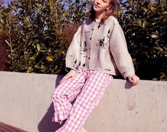 Pink and white checkered trousers, in the style of Scandinavian hygge handmade, charming straight cut finished with a ruffle