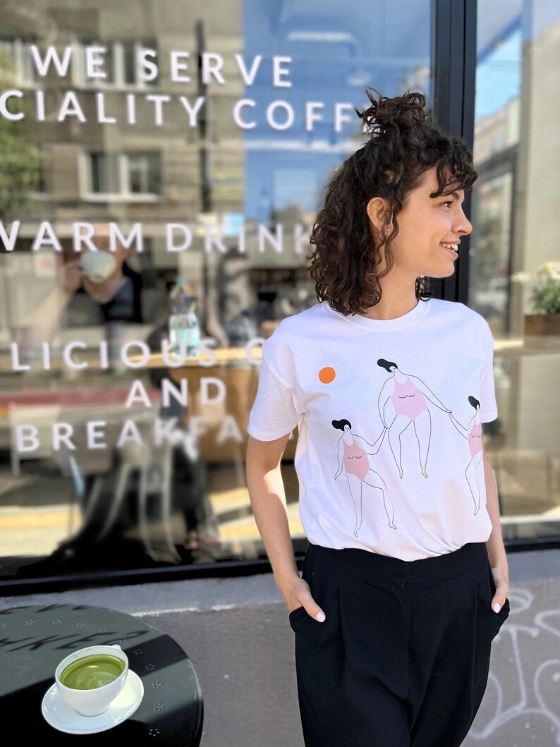 T-shirt with the story of a dream designed by Anna Lubińska Lubek, beautiful light colors in the background of dancing beach girls image 3