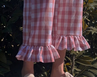 Pink and white checkered trousers, in the style of Scandinavian hygge handmade, charming straight cut finished with a ruffle