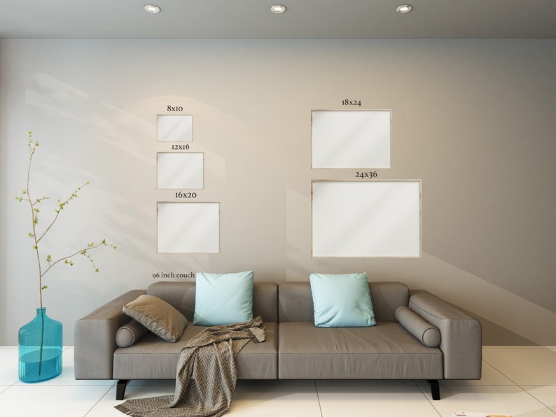 May include: A display of framed art prints in various sizes, including 8x10, 12x16, 16x20, 18x24, and 24x36 inches, mounted on a neutral-toned wall. A gray sofa with light blue pillows and a patterned throw is in the foreground.