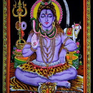May include: A colorful tapestry depicting the Hindu deity Shiva, seated in a meditative pose with a snake around his neck. He is adorned with jewelry and surrounded by symbols of his power, including a trident, a tiger, and a cow. The tapestry is framed with a gold border.