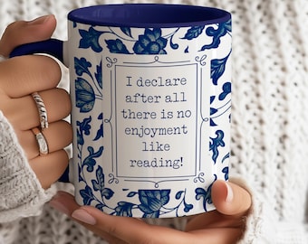 May include: White ceramic mug with a blue and white floral pattern. The mug has a blue rim and handle. The text on the mug reads "I declare after all there is no enjoyment like reading!"