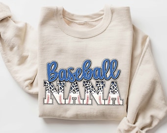 May include: A beige sweatshirt with the text "Baseball Nana" in blue and black lettering with a baseball and stitching pattern.