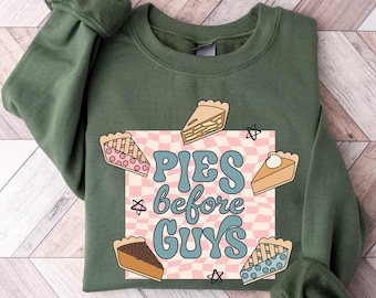 May include: Green sweatshirt with a graphic of pie slices and the text "Pies before Guys" in a retro font.