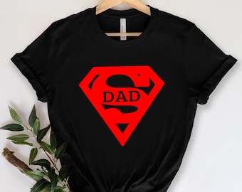 May include: Black t-shirt with a red Superman logo that says "DAD" inside the "S".