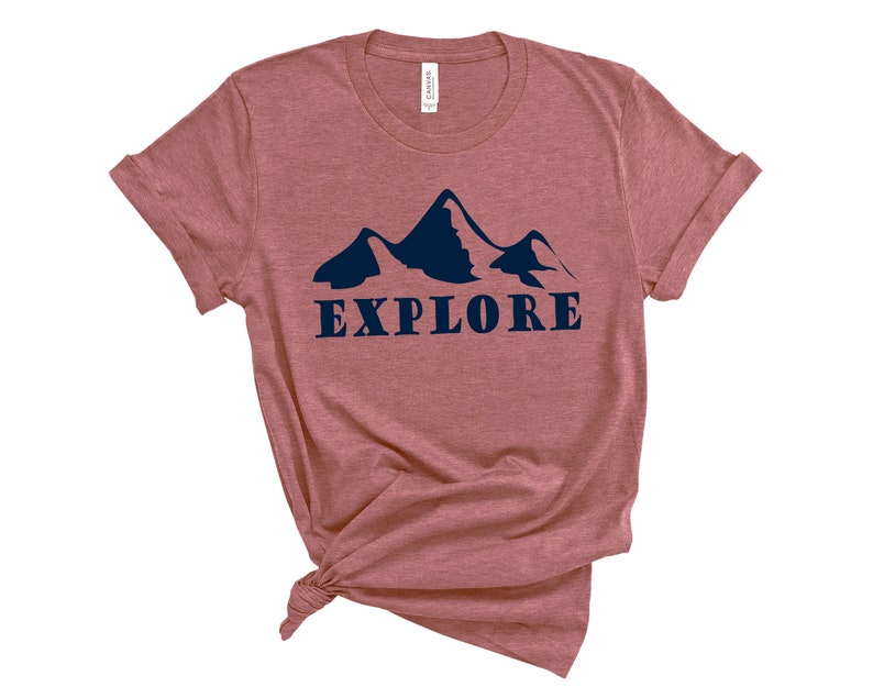 May include: A maroon t-shirt with a navy blue mountain silhouette and the word "EXPLORE" printed on the front.