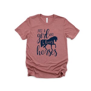 May include: A dusty rose t-shirt with a navy blue graphic that says "Just a girl who loves horses" with a silhouette of a horse.