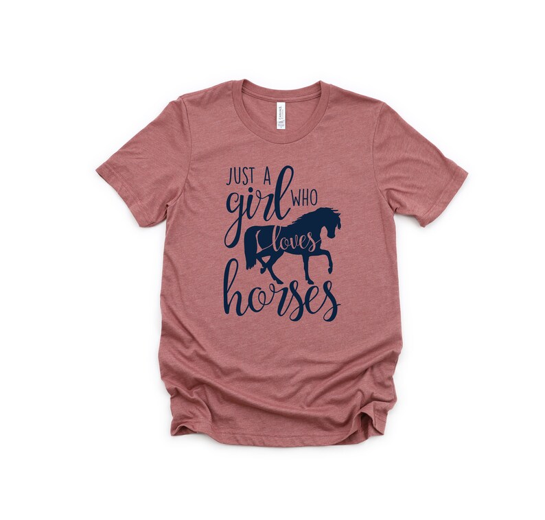 May include: A dusty rose t-shirt with a navy blue graphic that says "Just a girl who loves horses" with a silhouette of a horse.