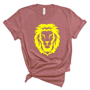 May include: A maroon t-shirt with a yellow lion head graphic.