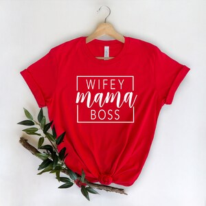 May include: Red t-shirt with white text that reads "WIFEY mama BOSS" in a box.