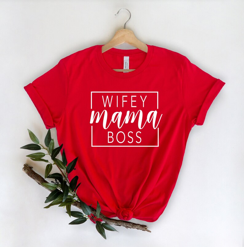 May include: Red t-shirt with white text that reads "WIFEY mama BOSS" in a box.