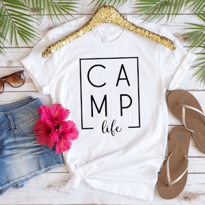 May include: White t-shirt with black text that reads "CAMP life" inside a black square.