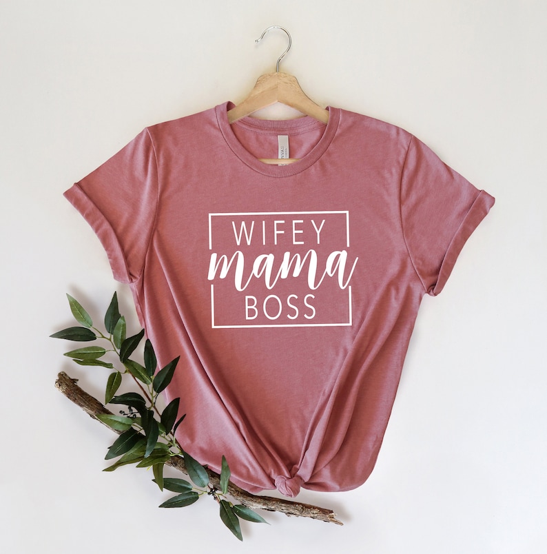 May include: A pink t-shirt with the text "WIFEY mama BOSS" in a white box.
