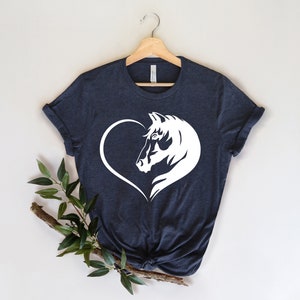 May include: A dark blue t-shirt with a white horse head silhouette inside a heart.