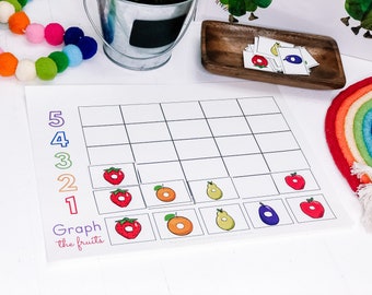 May include: A printable worksheet for a fruit graphing activity. The worksheet has a grid with numbers 1-5 on the left side and spaces for fruit images. The fruit images are strawberries, oranges, pears, eggplants, and apples. The text "Graph the fruits" is at the bottom of the worksheet.