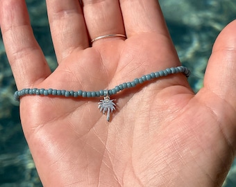 Cute stretchy anklet or bracelet made with 8/0 seed beads in your choice of color with a sterling silver palm tree charm.