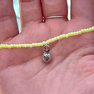 Cute stretchy anklet or bracelet made with 8/0 seed beads in your choice of color with a sterling silver pineapple charm!