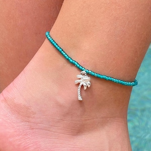 Cute stretchy anklet or bracelet made with 8/0 seed beads in your choice of color with a silver palm tree charm.