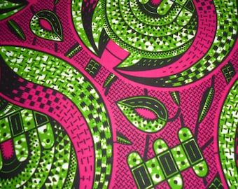 May include: Close-up of a vibrant fabric with a repeating pattern. The design features bold swirls and shapes in bright green, black, and white against a vivid pink background. The fabric has a textured appearance.