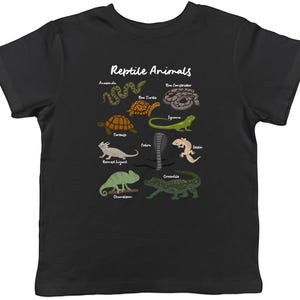 May include: Black t-shirt with a colourful illustration of reptiles, such as a snake, turtle, and lizard. The text "Reptile Animals" is printed above the illustrations. A fun and educational design for reptile enthusiasts.