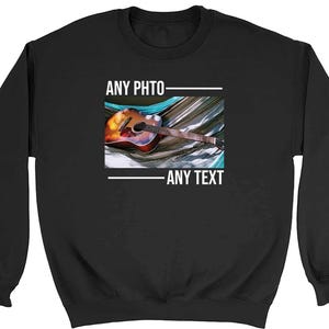 May include: Black sweatshirt with a white graphic of a guitar in a hammock. The text "ANY PHOTO" and "ANY TEXT" is printed above and below the image.