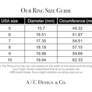 May include: A white ring size guide with black text. The guide includes USA ring sizes 5 through 10, with corresponding diameter and circumference measurements in millimeters. The text "OUR RING SIZE GUIDE" is at the top.