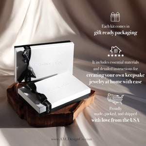 May include: Two white boxes with black trim, tied with black ribbons, are displayed on a wooden surface. The boxes are embossed with "AXC Design & Co." and the text "Each kit comes in gift ready packaging" is visible. The image suggests a jewelry-making kit.