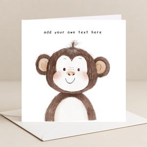 May include: A square greeting card with a watercolour illustration of a smiling monkey. The monkey has brown fur, pink cheeks, and large ears. The text "add your own text here" is above the monkey. The card is on a white envelope.