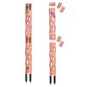 May include: Two wooden garden stakes with a natural finish, featuring an open, oval design. The stakes have black pointed ends for easy ground insertion. Additional wooden connectors are also shown, suggesting an assembly process. The stakes are labeled with the text "Etta by Tricia".