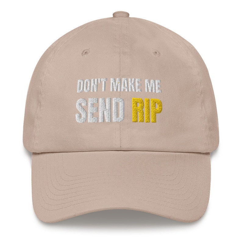 Puede incluir: Una gorra de b&eacute;isbol beige con el texto "Don't make me send rip" bordado en blanco y amarillo.
