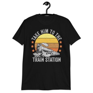 May include: Black t-shirt with a vintage-style graphic of a train with the text "Take Him To The Train Station".