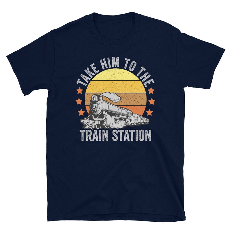May include: Navy blue t-shirt with a vintage-style illustration of a train engine and the text "Take Him To The Train Station".