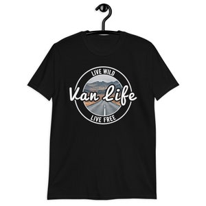 May include: Black t-shirt with a white circle graphic that says "Live Wild Van Life Live Free" with a picture of a road in the mountains.