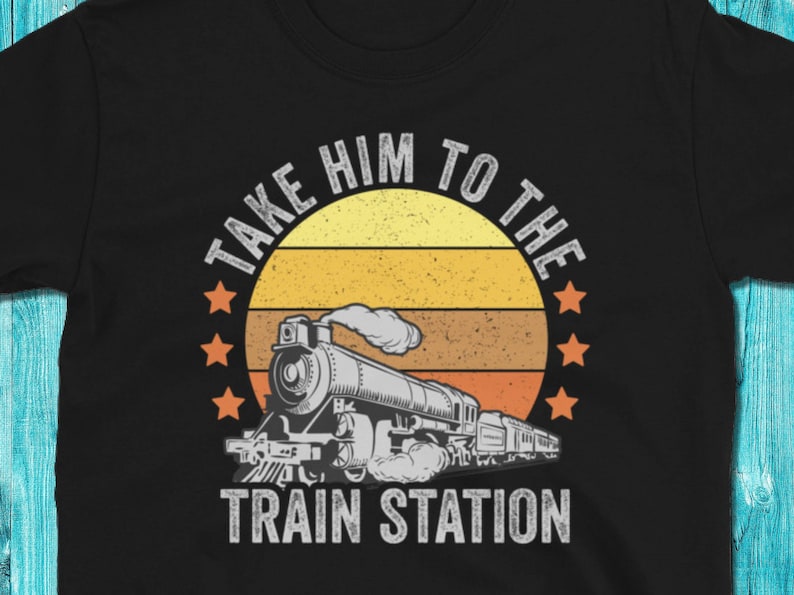 May include: A black t-shirt with a vintage-style graphic of a train engine with the text "Take Him To The Train Station".